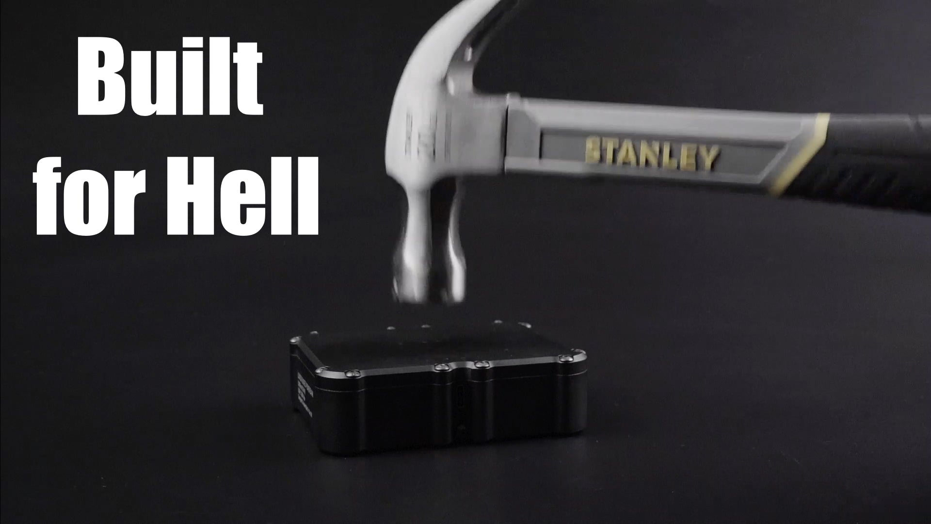 Stanley hammer striking a ldx100 real rugged powerbank on a dark background with 'Built for Hell' text.